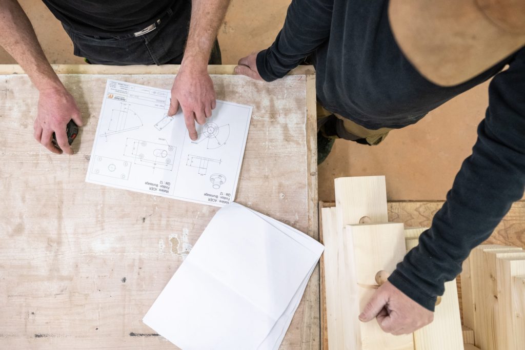 menuisiers qui discutent autour d'un plan